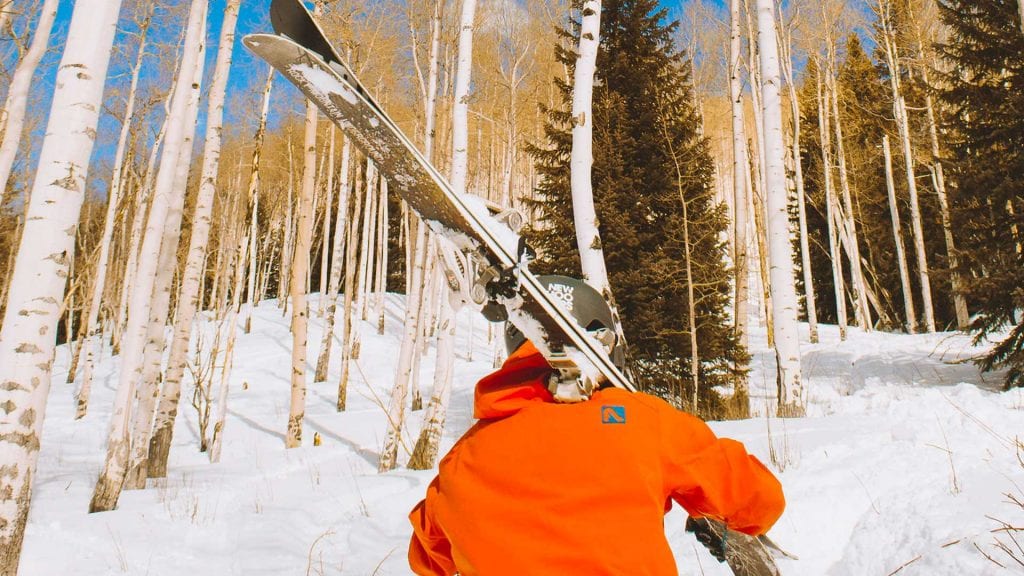 carrying skis into aspens