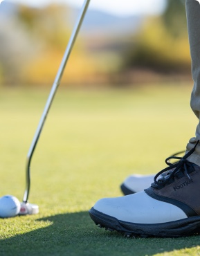 A person lines up a putt while golfing.