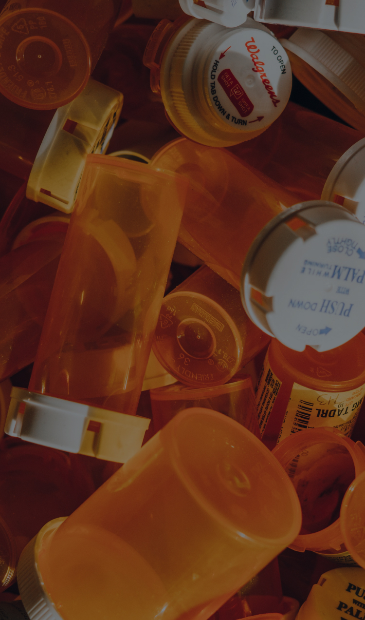 A collection of orange prescription bottles.