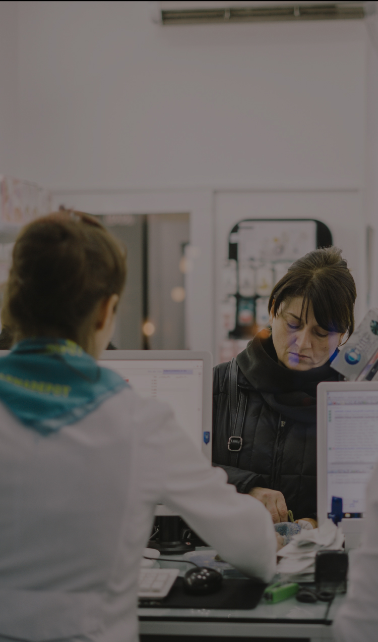 A woman stands in line at the pharmacy.