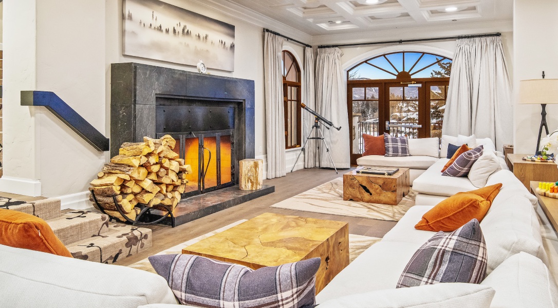 Spacious lobby with couches, tall windows, and large fireplace