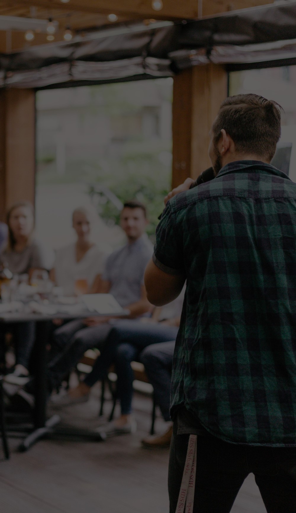 Man Speaking in Front of Crowd at Restaurant