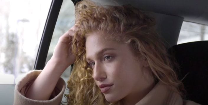 woman leaning head on hand looking concerned