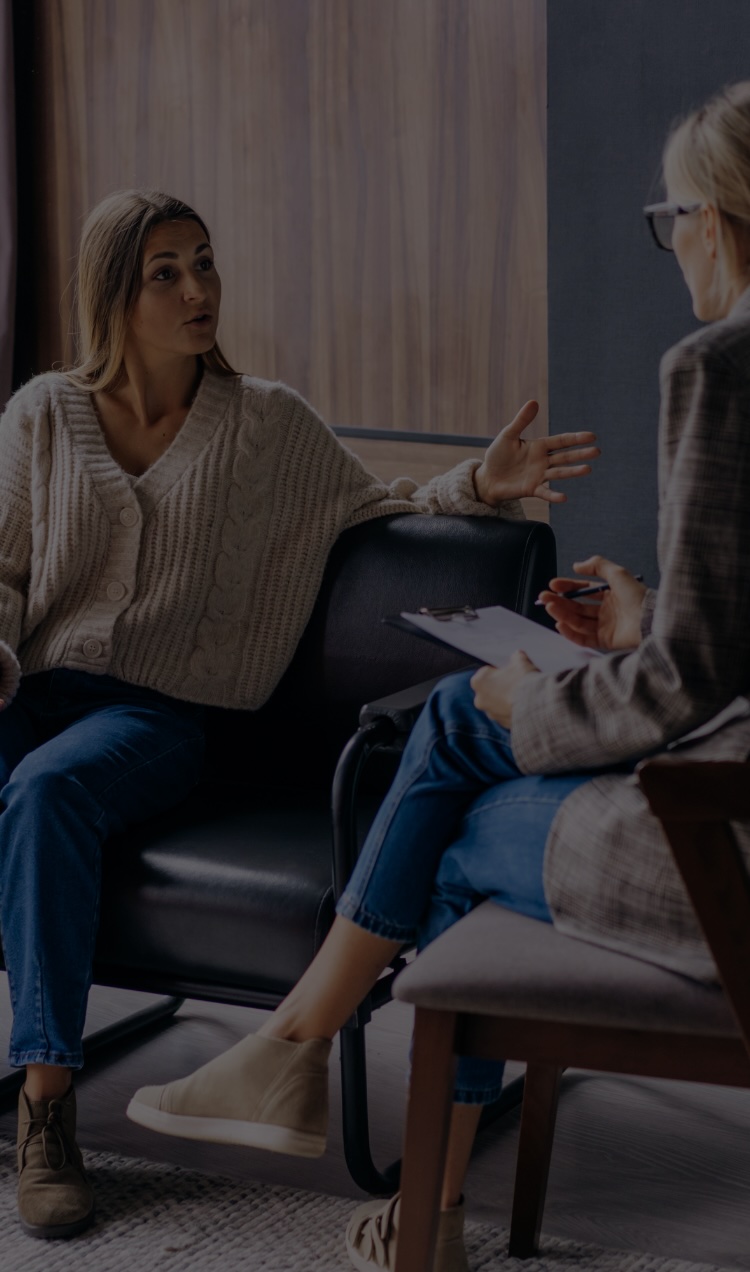 A woman discusses mental health stigma with a therapist.