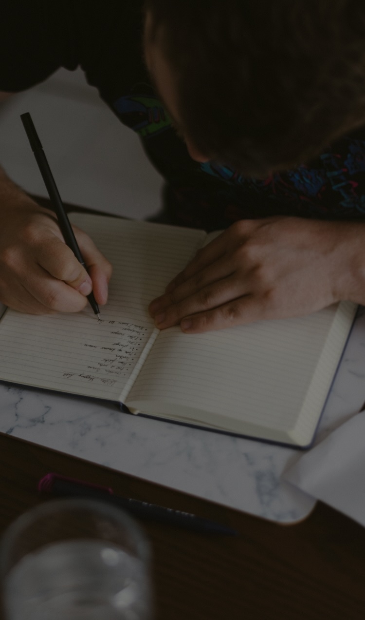 A person works on their relapse prevention plan during a journaling session.