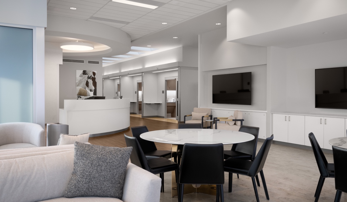 Lobby of detox center with front desk, couch, table, and television