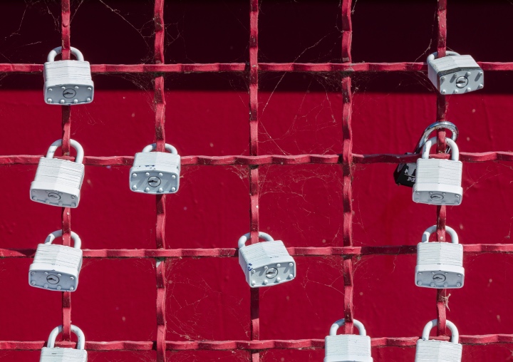A red metal grid with locks.