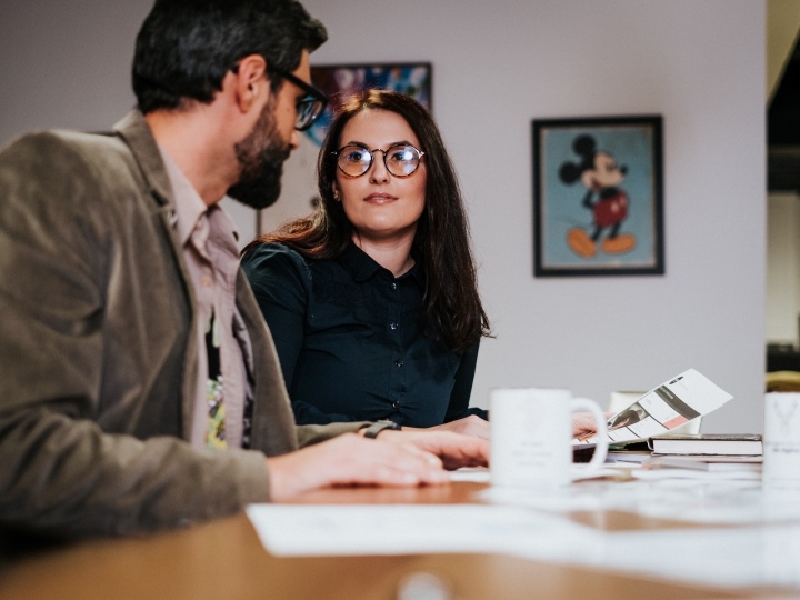 Woman and Man Looking at Each Other During Meeting
