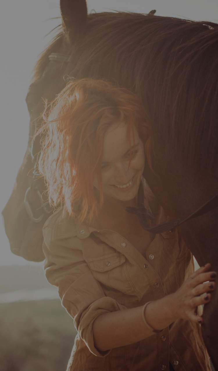 A woman hugs a horse during an equine-assisted therapy session.