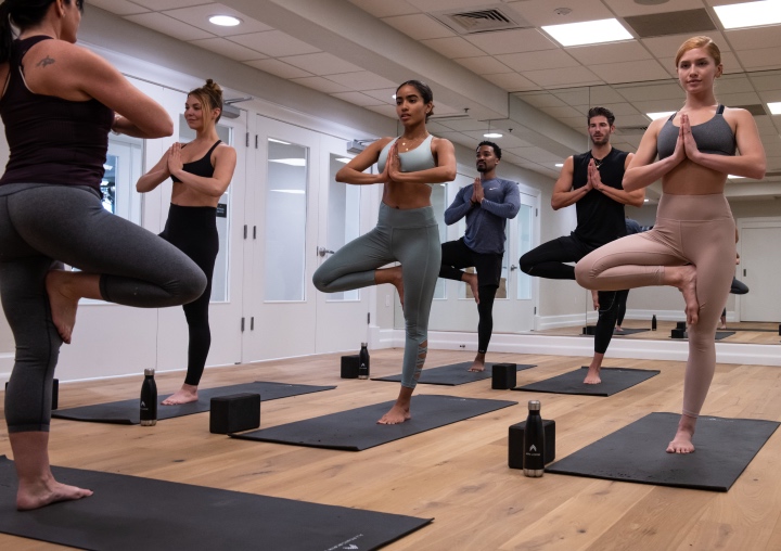 A group of clients participate in a yoga class at All Points North Lodge.