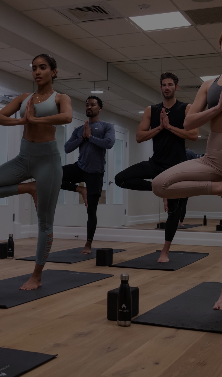 A group of clients participate in a yoga class at All Points North Lodge.