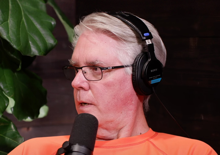 Greg Callaghan talks into a microphone on the Harder Than Healing podcast.