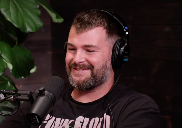 Steve Hueston talks into a microphone on the Harder Than Healing podcast.