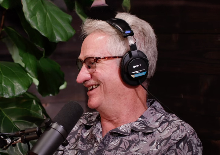 Craig Knippenberg talks into a microphone on the Harder Than Healing podcast.