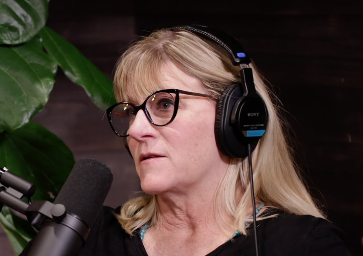 Megan Marx talks into a microphone on the Harder Than Healing podcast.