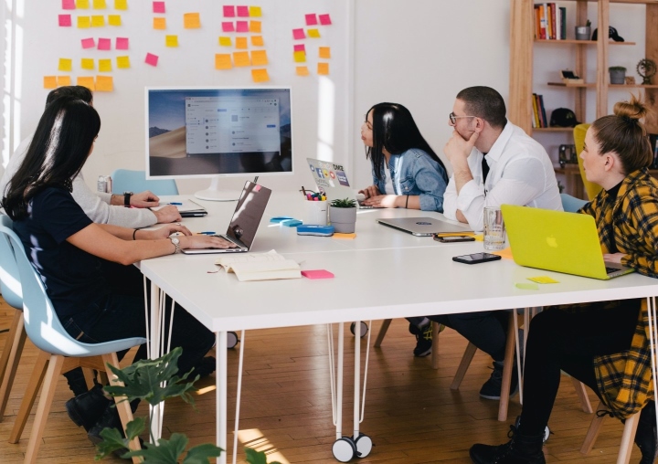 Team Meeting at Conference Table Around Computer