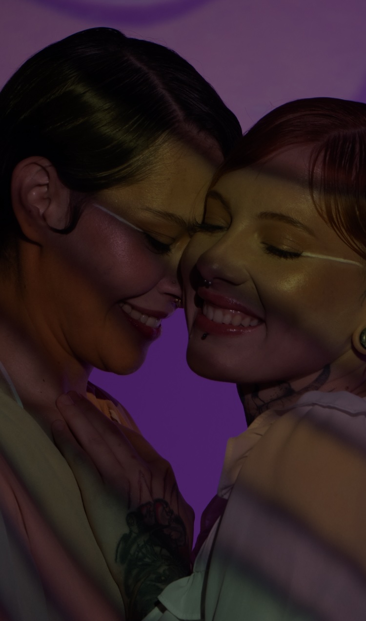 A couple has an intimate moment at a club.