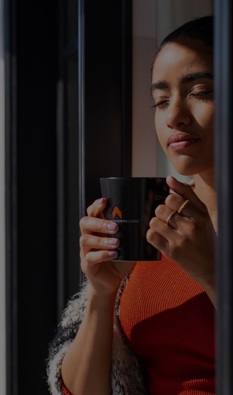 Woman Holding Mug on Balcony