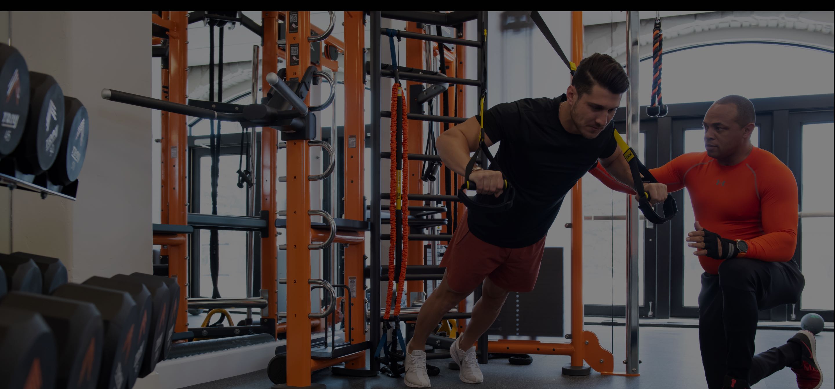 A client and a personal trainer complete a workout at the gym at All Points North Lodge.