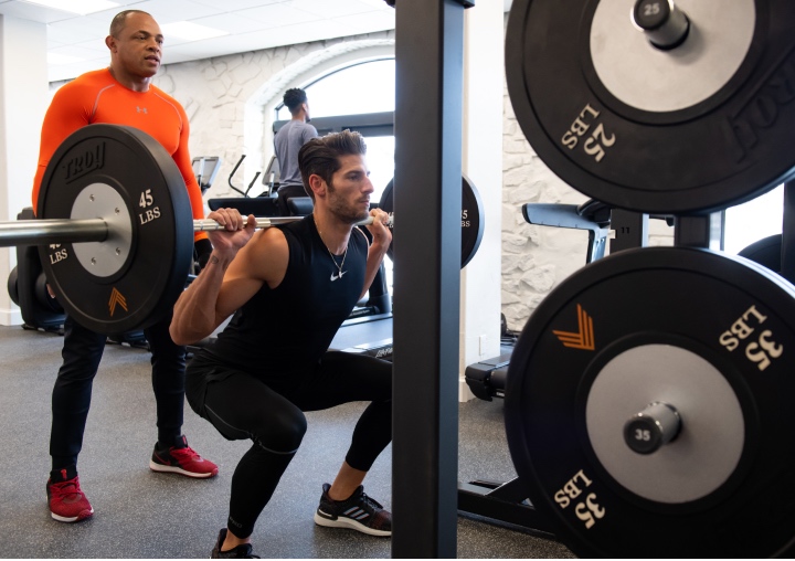 A client and a personal trainer complete a workout at the gym at All Points North Lodge.
