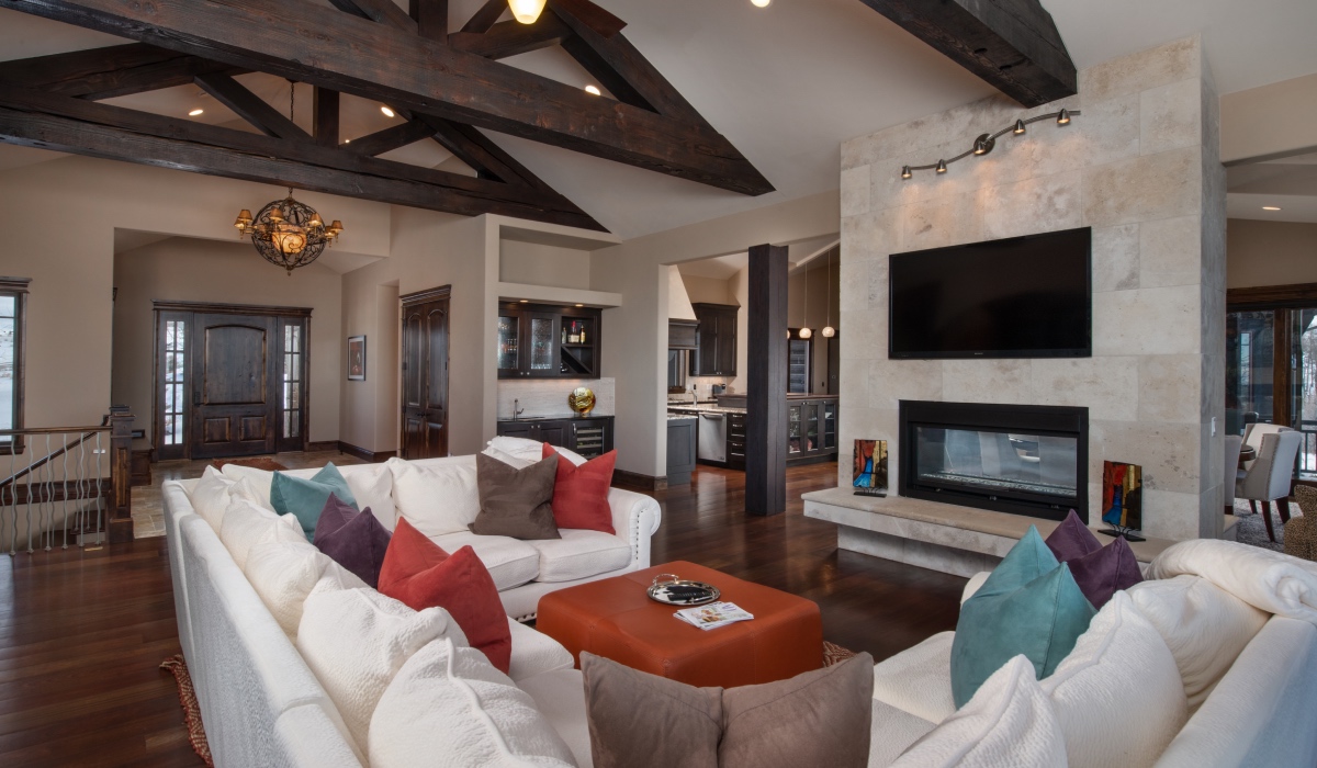 living room with white couch, fireplace, and television