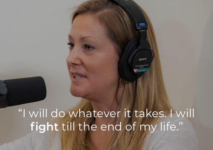 Katy speaking into a podcast microphone with a text overlay: I will do whatever it takes. I will fight till the end of my life.