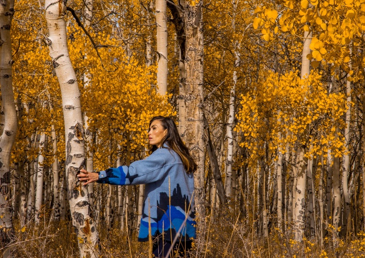 A Revive Retreat client stands among the aspen trees.
