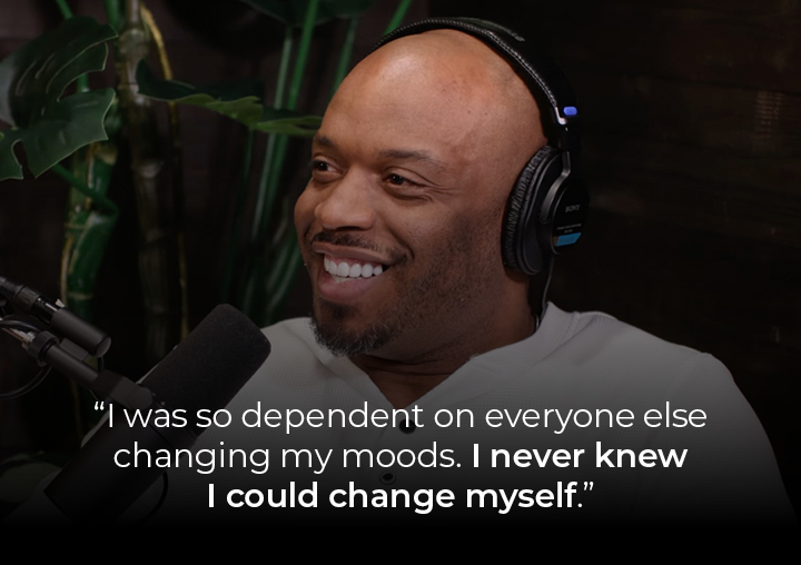 John Abraham speaking into a podcast microphone with a text overlay: I was so dependent on everyone else changing my moods. I never knew I could change myself.