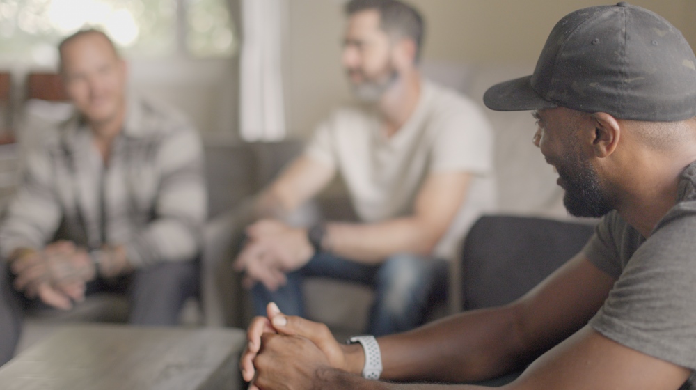 Veteran talking in a circle with other men