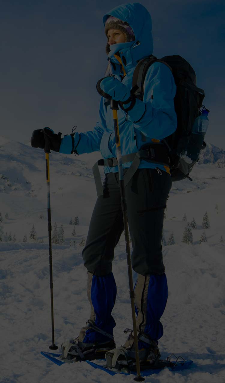 Someone looking out over a snowy landscape while snowshoeing