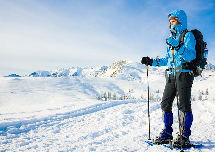 Someone looking out over a snowy landscape while snowshoeing