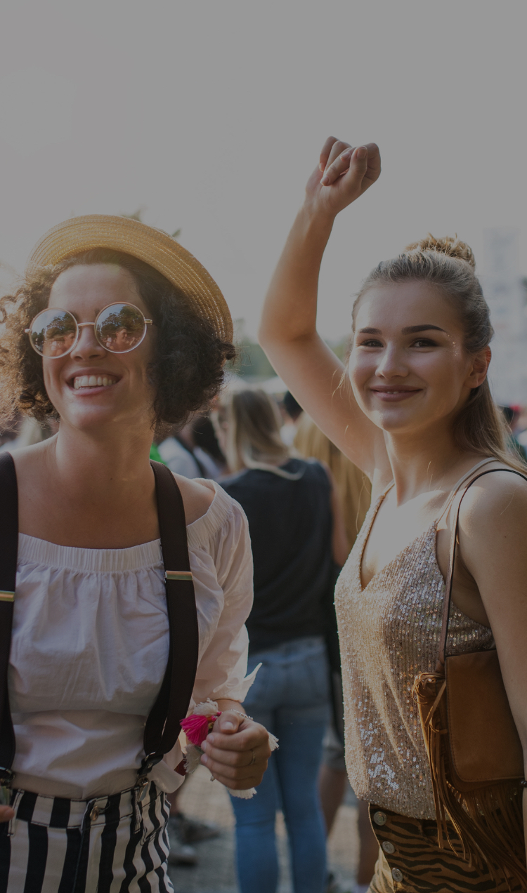Two women enjoy a sober music festival.