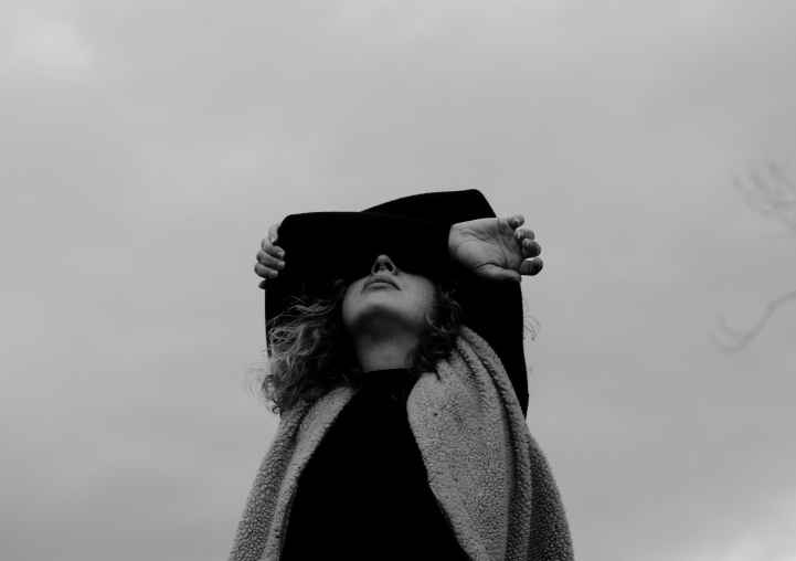 Woman Outside with Arms Over Her Face in Shame