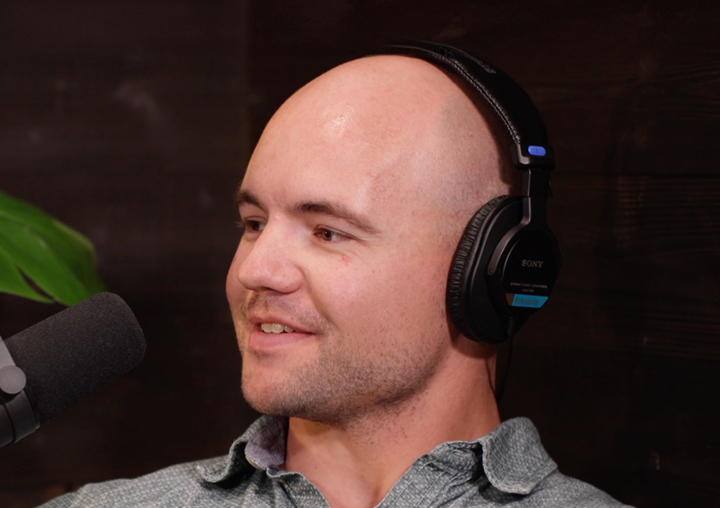 Chris Borland talks into a microphone on the Tackling Stigma podcast miniseries.
