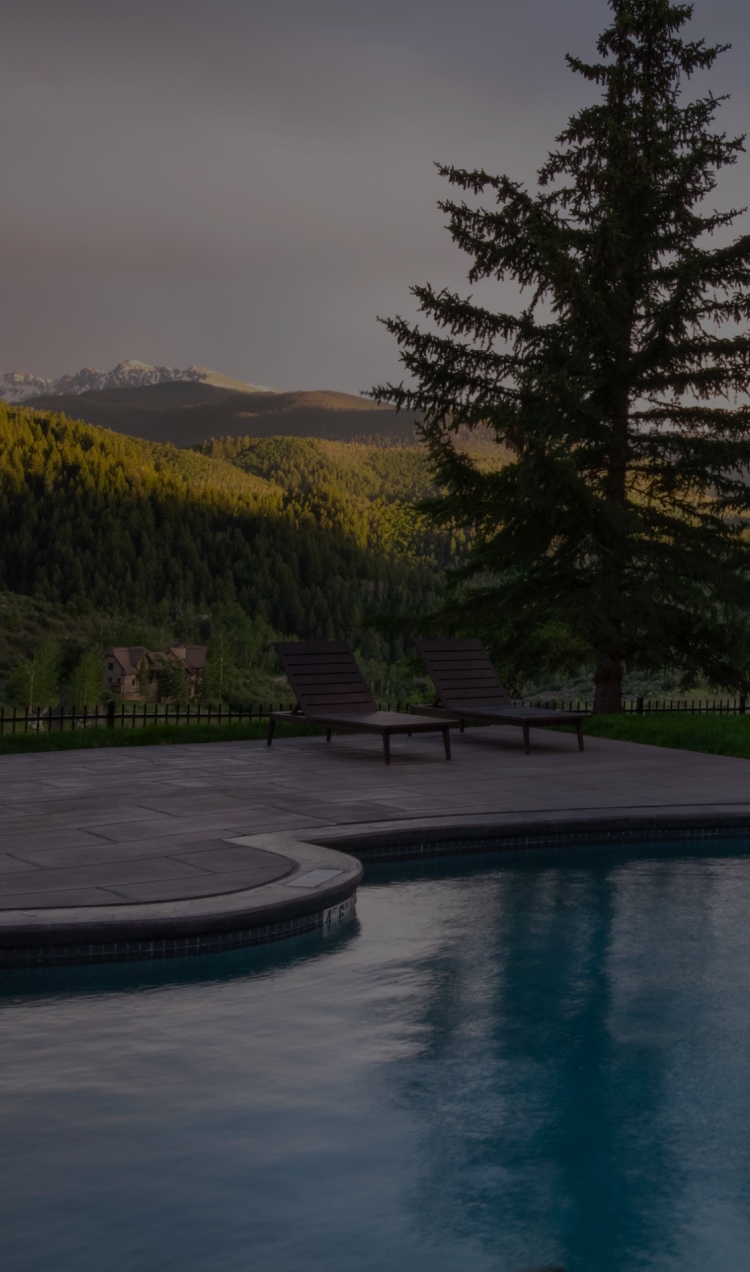The outdoor pool with mountain views at All Points North Lodge.