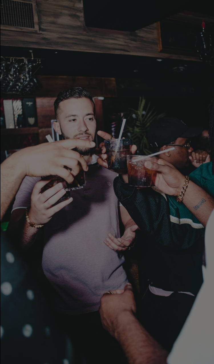 People toasting at a club.