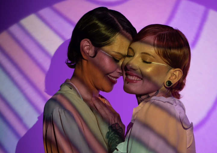 A couple has an intimate moment at a club.
