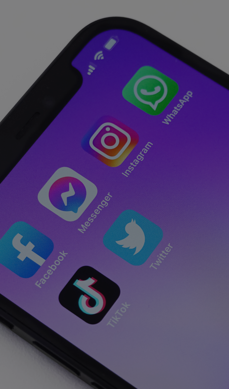 An iPhone with a purple background and collection of social media apps.