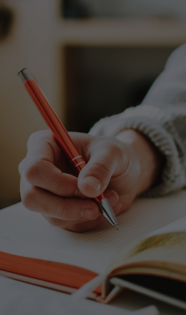 Bullet journaling with an orange pen.