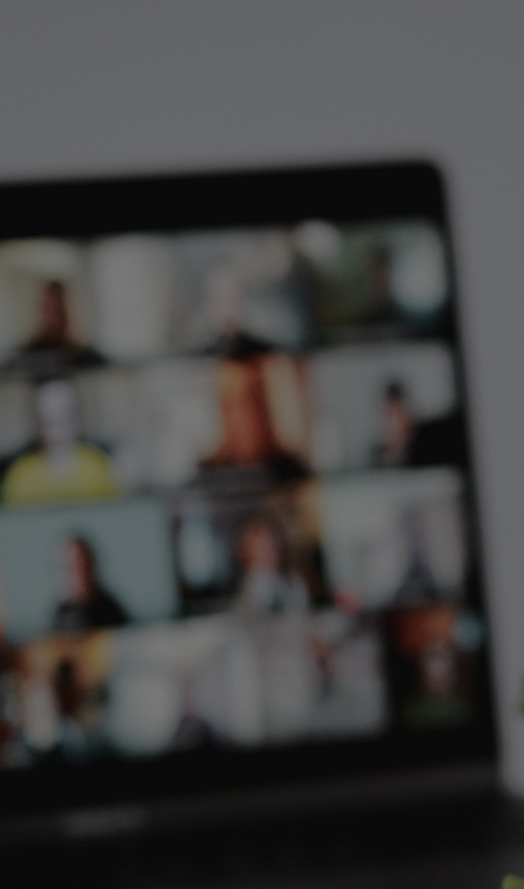 A blurry laptop screen with a gallery view of Zoom.