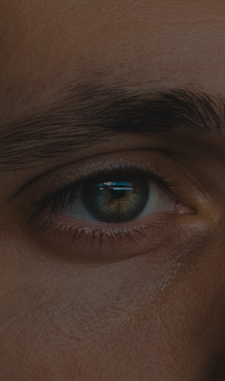A man looks indirectly into the distance.